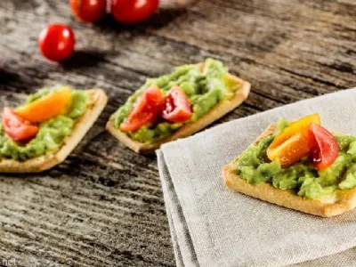 Krekerji Snackers z namazom gvakamole in češnjevimi paradižniki 