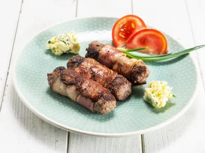 Čevapčiči s slanino in zeliščnim maslom